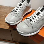 Light gray leather sneakers close-up, white laces, cushioned collar and side panels