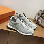 Light gray leather low-top sneakers, white laces and black heel detail, street sole