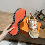 Hermes unisex sneaker outsole view with orange traction tread and white midsole edge