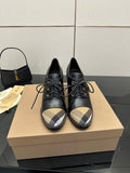 Black lace-up ankle boots with block heel and beige check toe panels