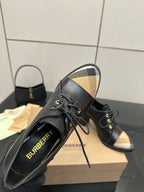 Black lace-up ankle boots with beige check panels and Burberry logo on uppers