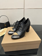 Black lace-up ankle boots with block heel and beige check toe panels