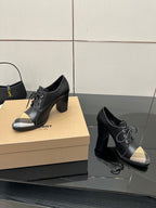 Black lace-up ankle boots with block heels and beige check toe panels, side angle