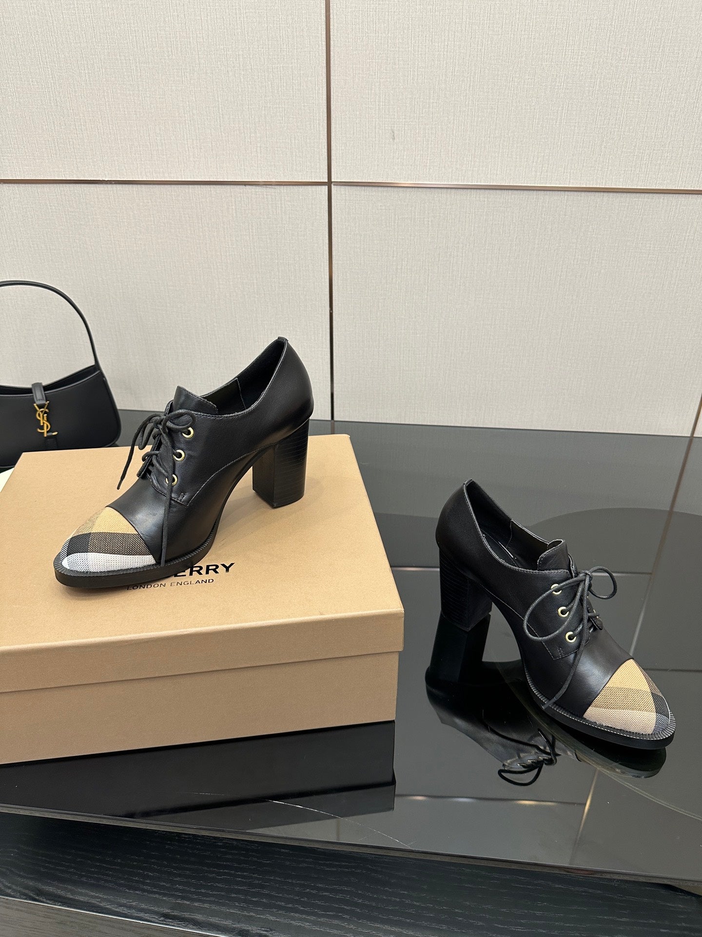 Black lace-up ankle boots with block heels and beige check toe panels, side angle