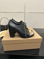 Black leather lace-up ankle boots with block heel and beige check toe detail