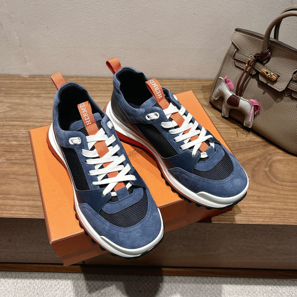 Hermes unisex sneakers pair, navy blue with white laces and orange heel branding