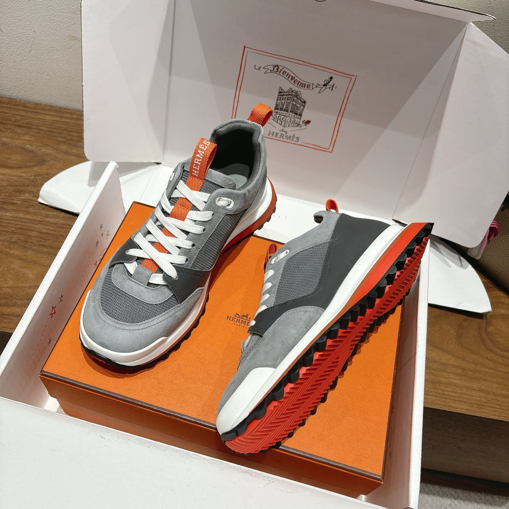 Grey sneakers plus matching grey shoe insert in orange shoebox