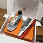 Grey sneakers plus matching grey shoe insert in orange shoebox