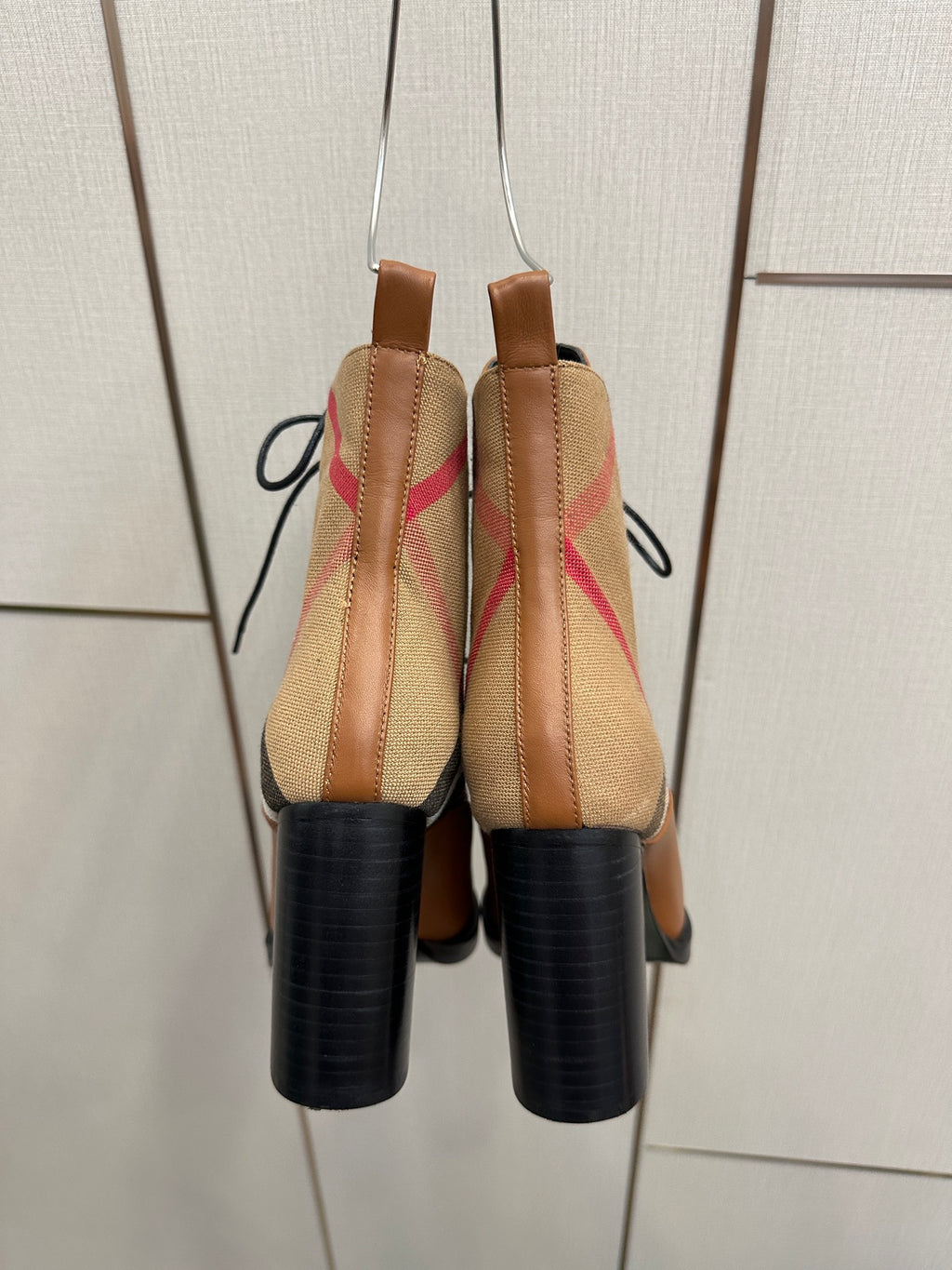 Back view of tan check lace-up ankle boots with black heel and elastic panels