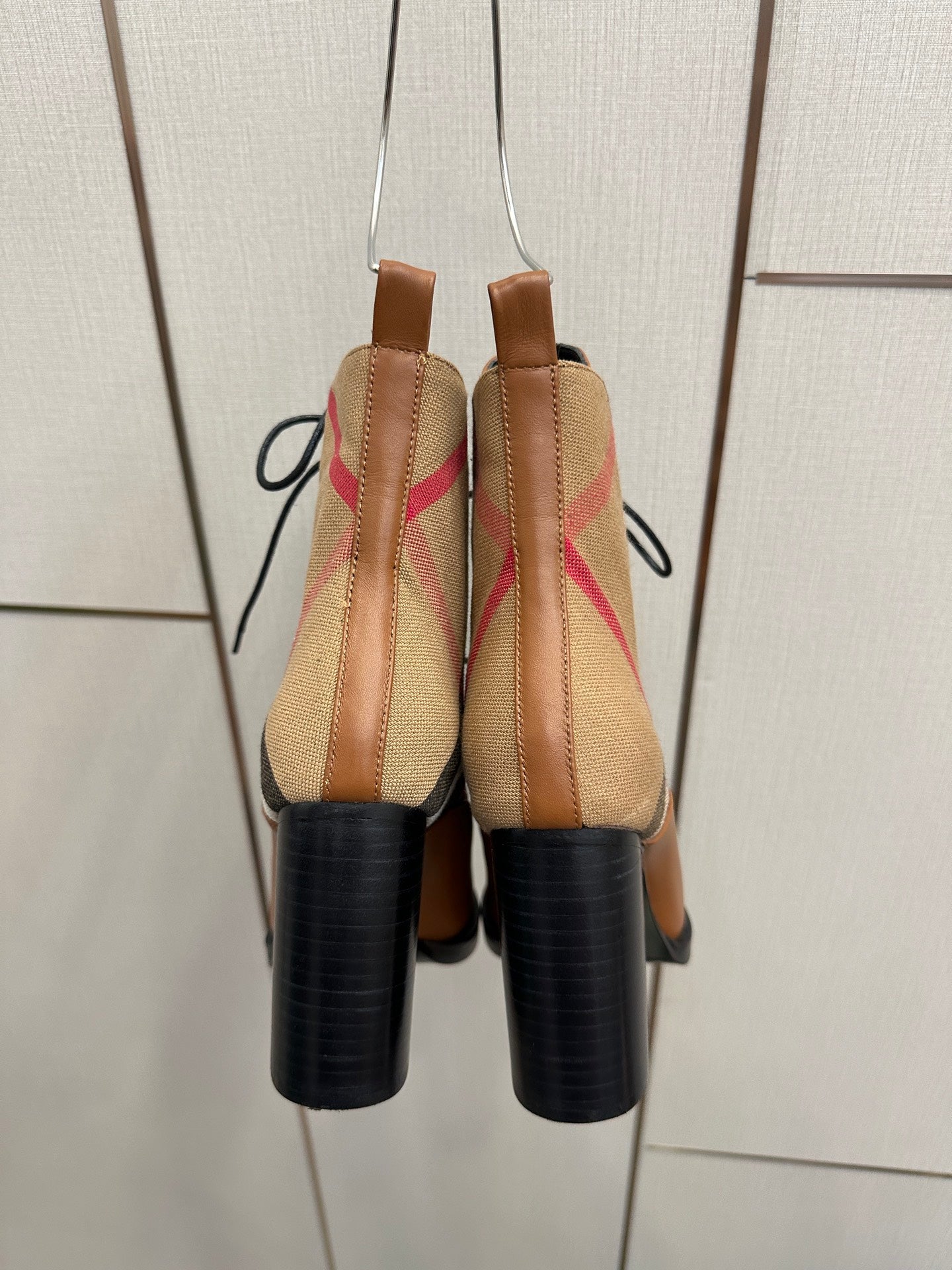 Back view of tan check lace-up ankle boots with black heel and elastic panels