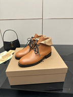Tan lace-up ankle shoes with black rubber sole and plaid cuff detail
