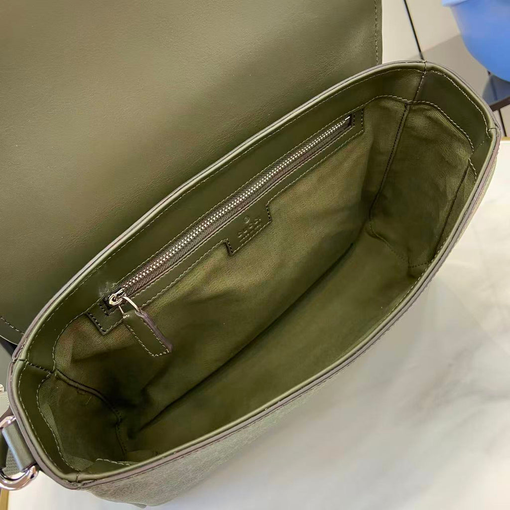 Gucci bag interior view with zippered pocket and green fabric lining