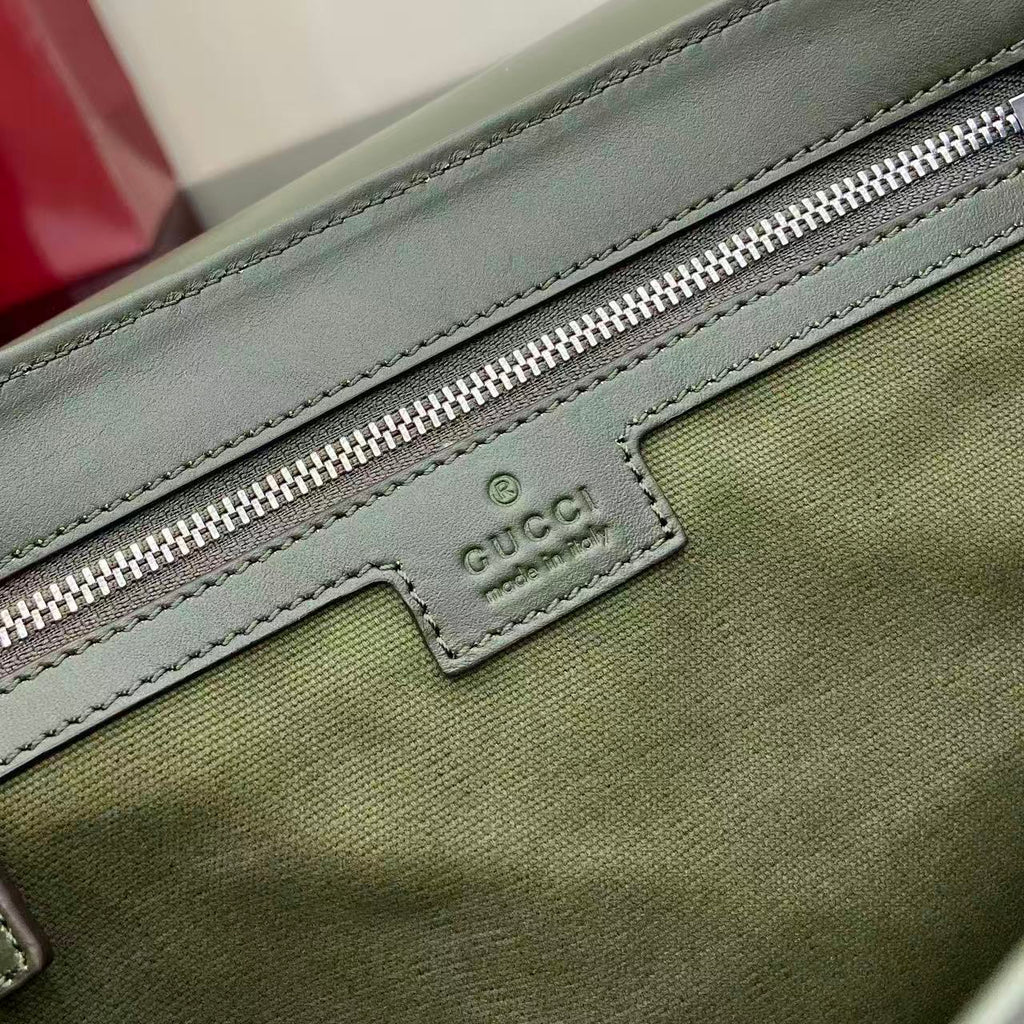 Gucci logo patch on green zip pocket with silver zipper and stitched border