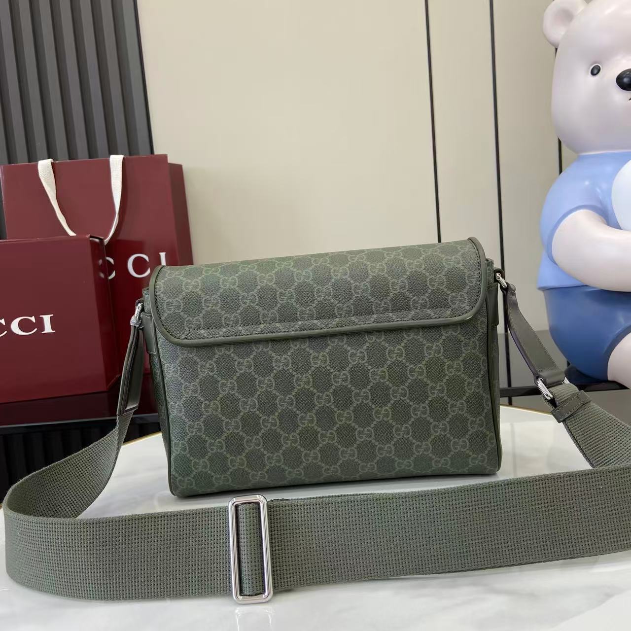 Gucci GG monogram flap shoulder bag with adjustable green strap and silver buckle