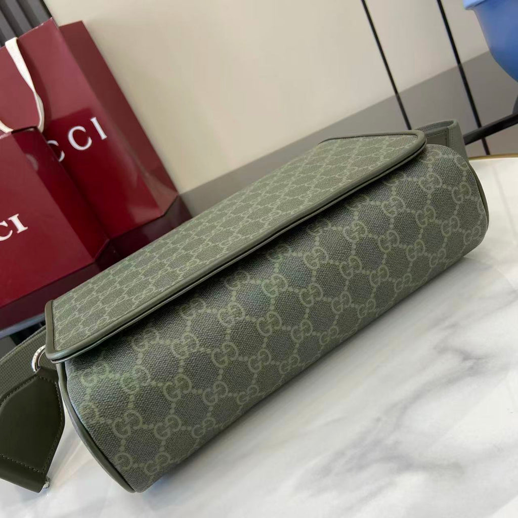 Gucci GG monogram shoulder bag lying flat, olive green canvas with flap