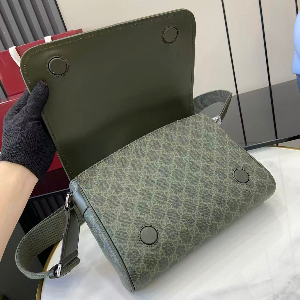 Gucci GG monogram bag with leather back panel, round studs, and shoulder strap