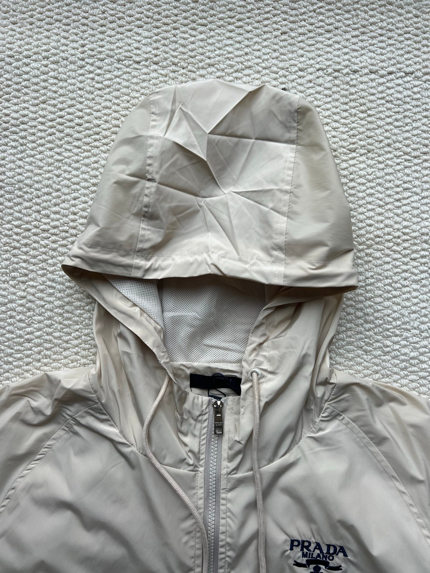 Prada hooded jacket, light beige, front zipper and chest logo under hood.