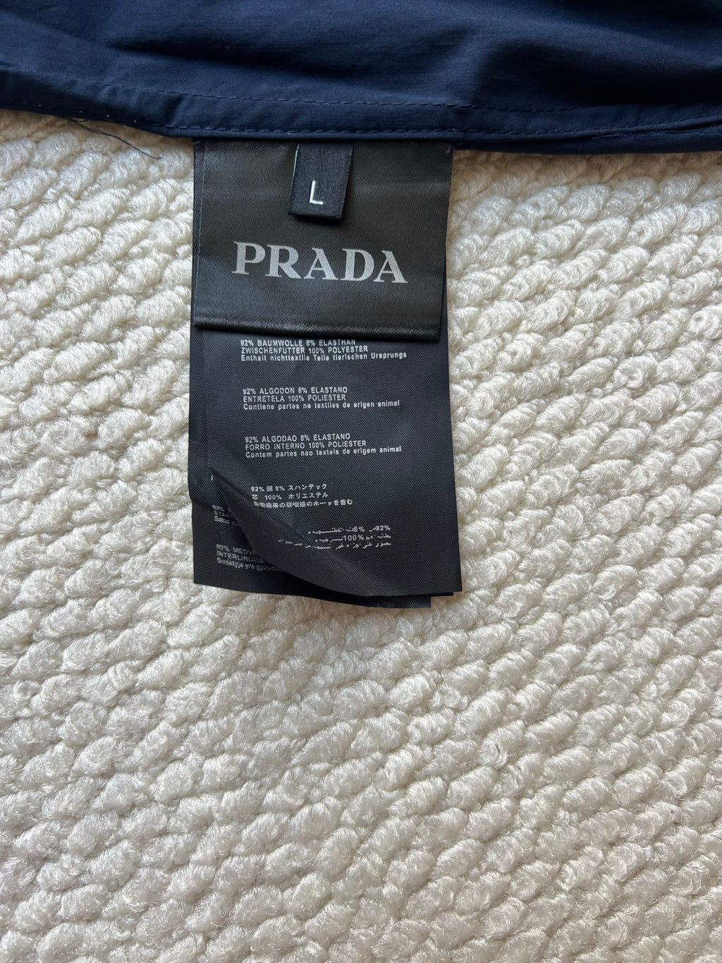 PRADA size L clothing label on navy hooded jacket