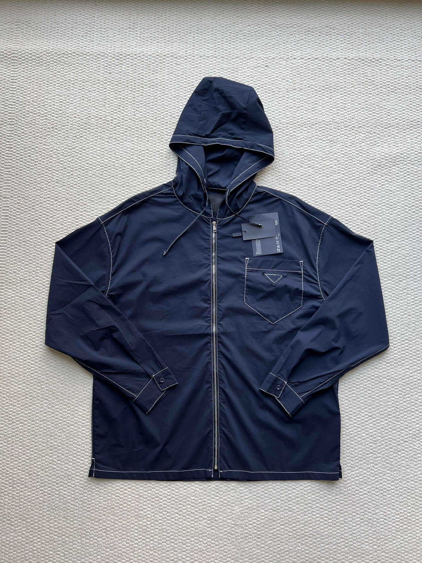 Men's navy hooded zip jacket with adjustable drawstring