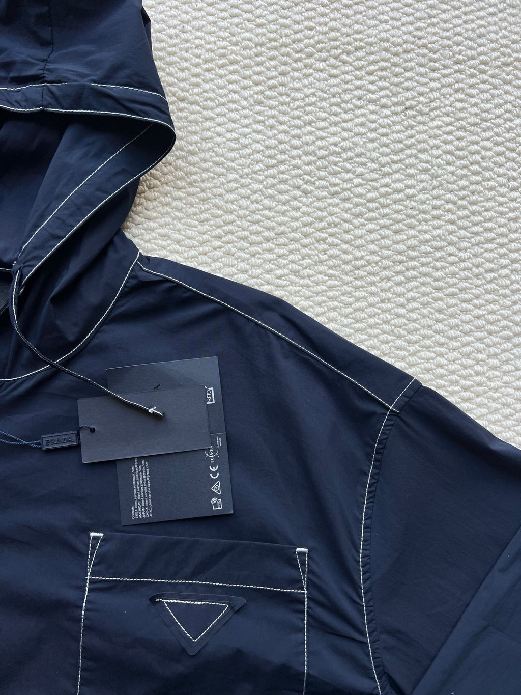 Men's navy hooded jacket with chest patch pocket and drawstring ties