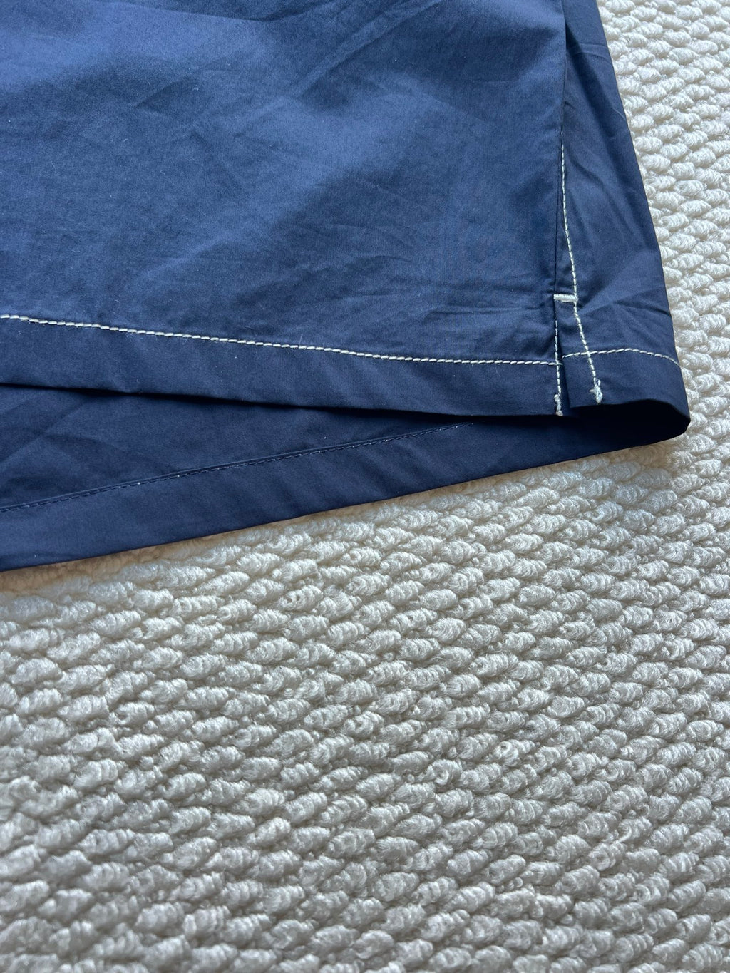 Men's navy hooded jacket hem with stitched seam and panel detail