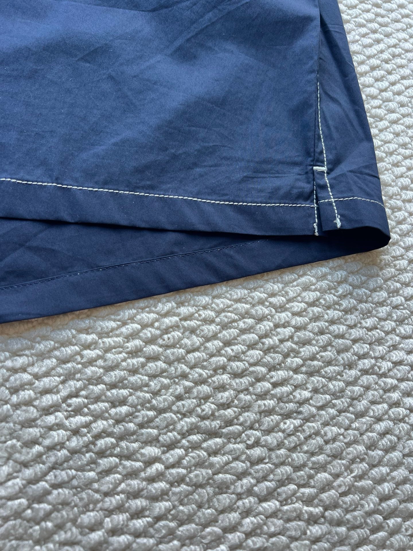 Men's navy hooded jacket hem with stitched seam and panel detail
