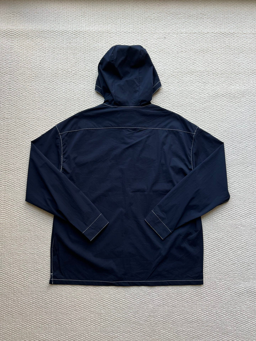 Men's navy hooded zip jacket, full back view with stitched panels