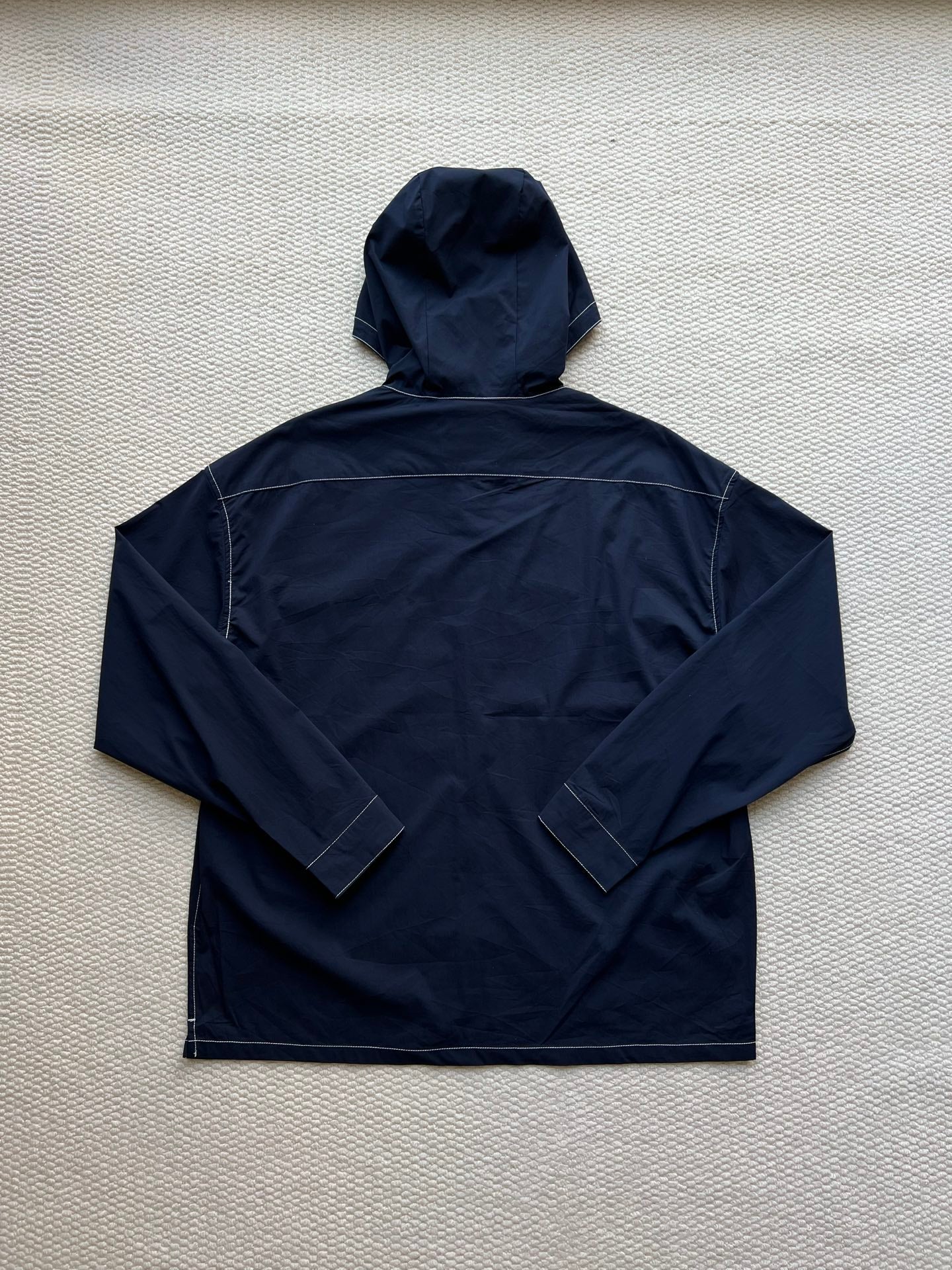 Men's navy hooded zip jacket, full back view with stitched panels