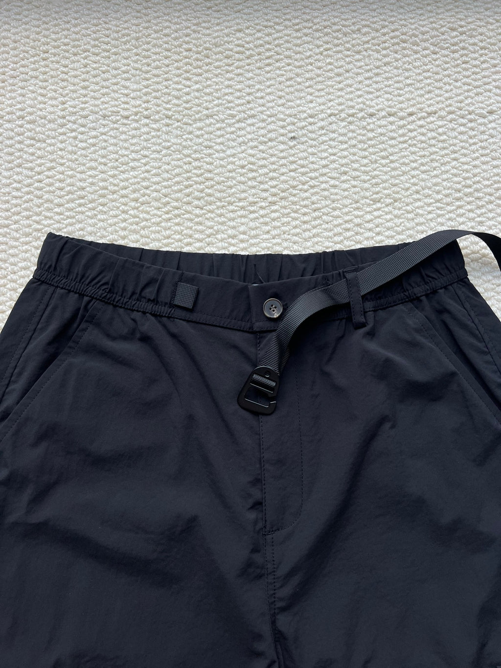 Stone Island cargo pants in dark navy with button front, belt loops, and drawstring