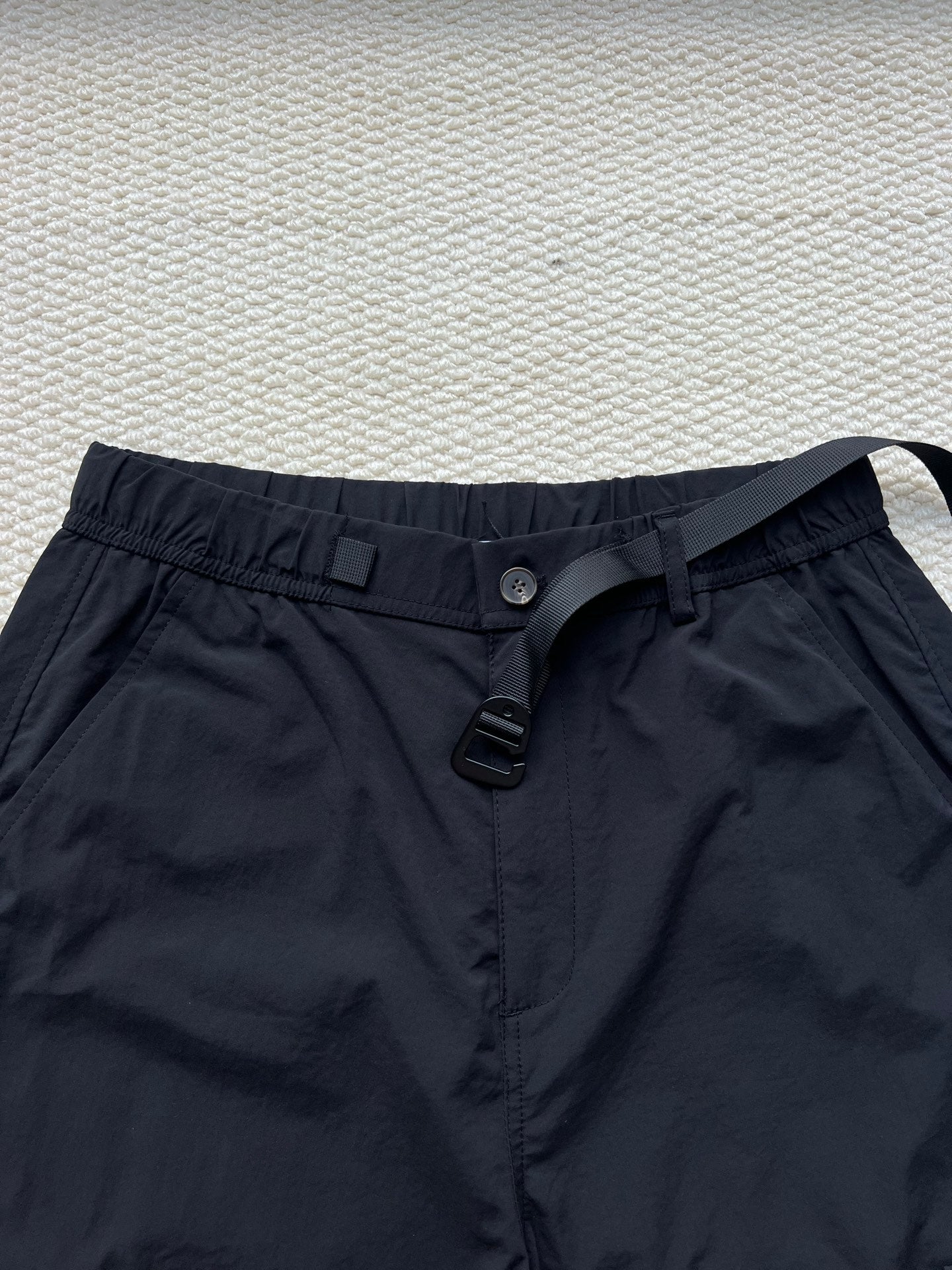 Stone Island cargo pants in dark navy with button front, belt loops, and drawstring