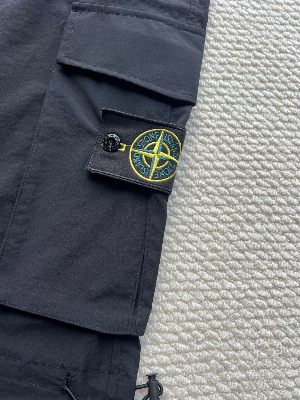 Stone Island cargo pants in dark navy with green logo patch on side pocket