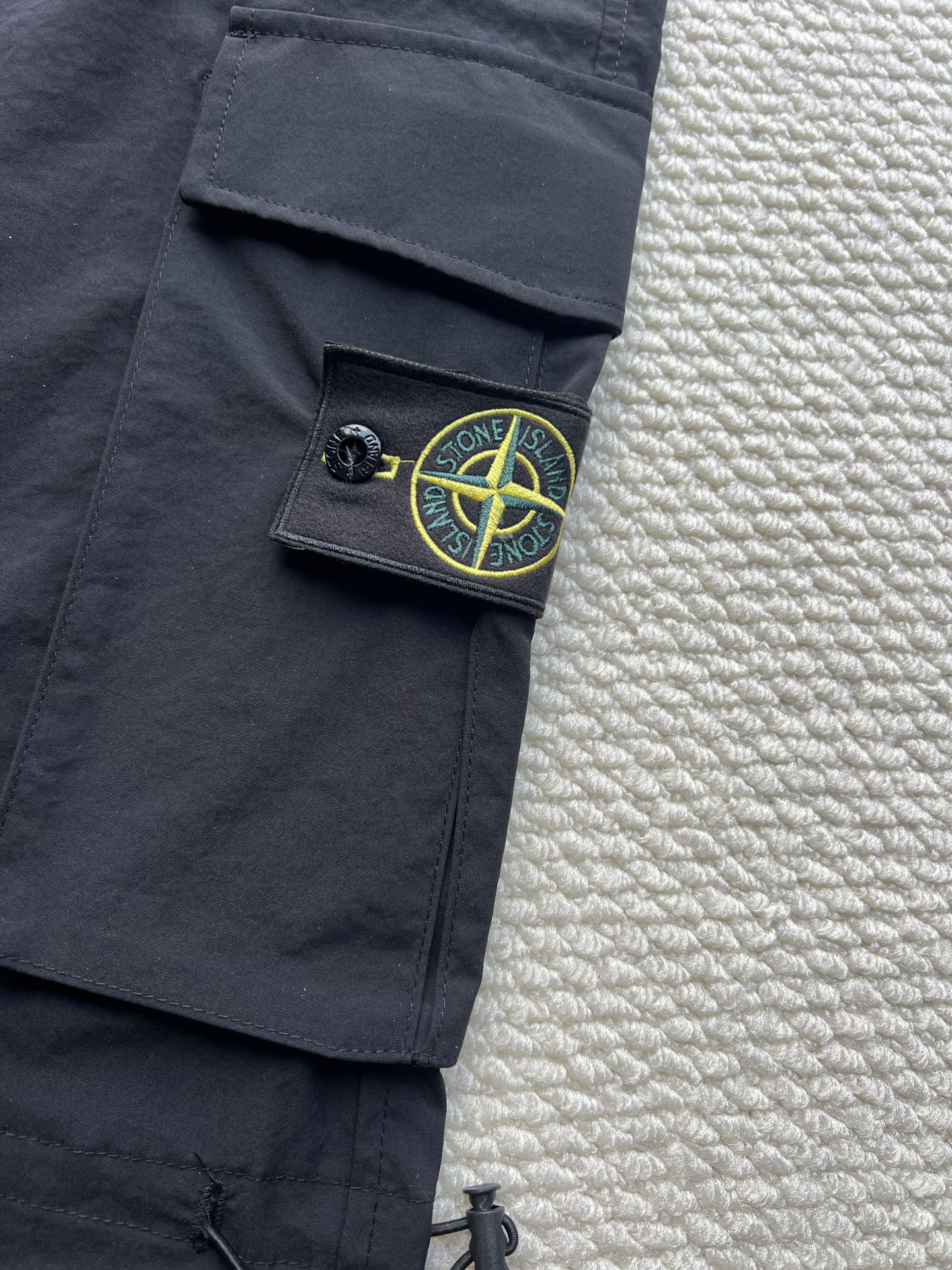 Stone Island cargo pants in dark navy with green logo patch on side pocket