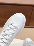 White leather sneaker toe and lace-up front with perforated eyelets