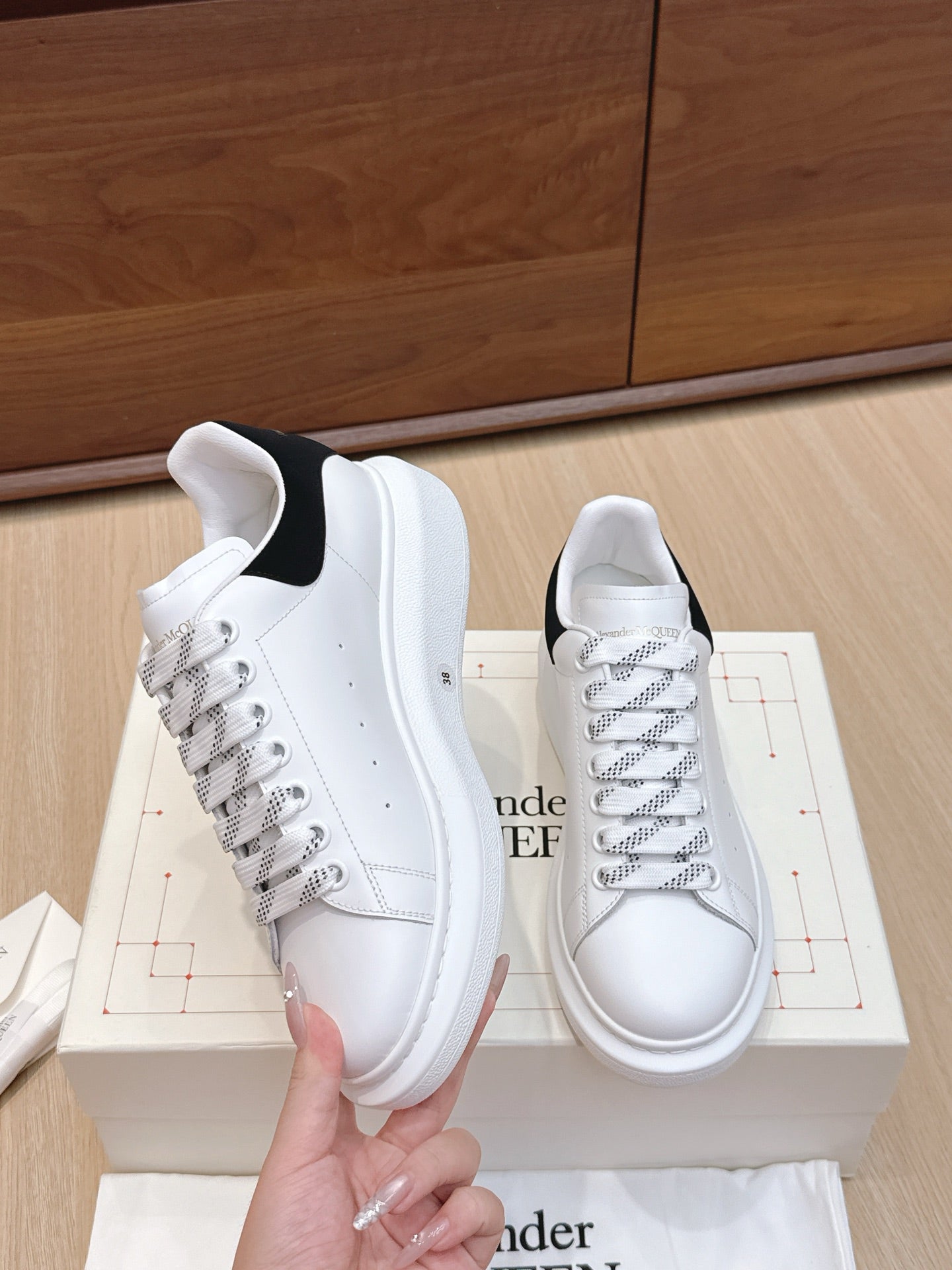 White leather low-top sneakers with black heel panel and textured sole