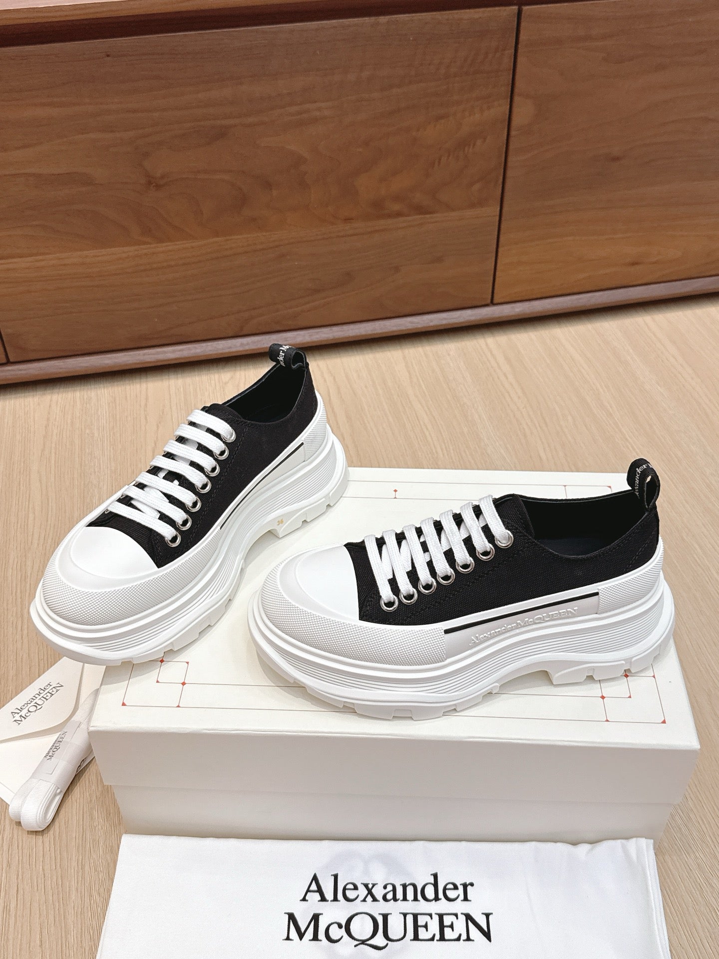 Black and white low-top sneakers with side stripe and chunky white sole