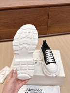 White rubber outsole of a black-and-white low-top sneaker
