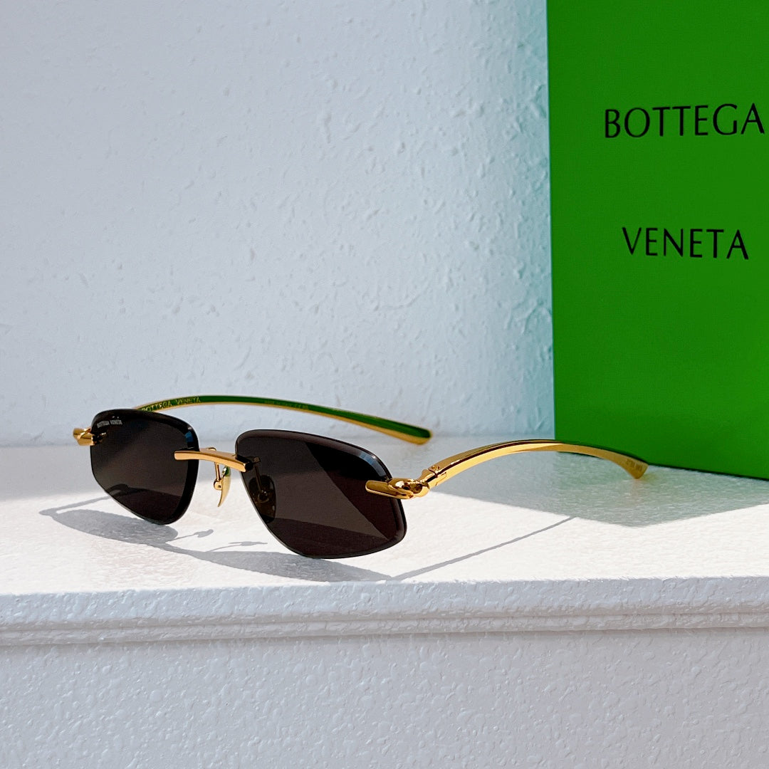 Bottega Veneta sunglasses with gold frame and dark tinted lenses, side view
