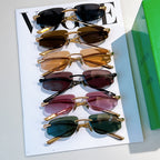 Bottega Veneta sunglasses assortment with tinted lenses and gold frames on cards