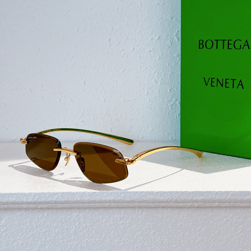 Bottega Veneta sunglasses with gold frame and amber tinted lenses, side view