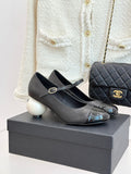 Black Mary Jane pumps with silver patent toe cap and round white heel accents