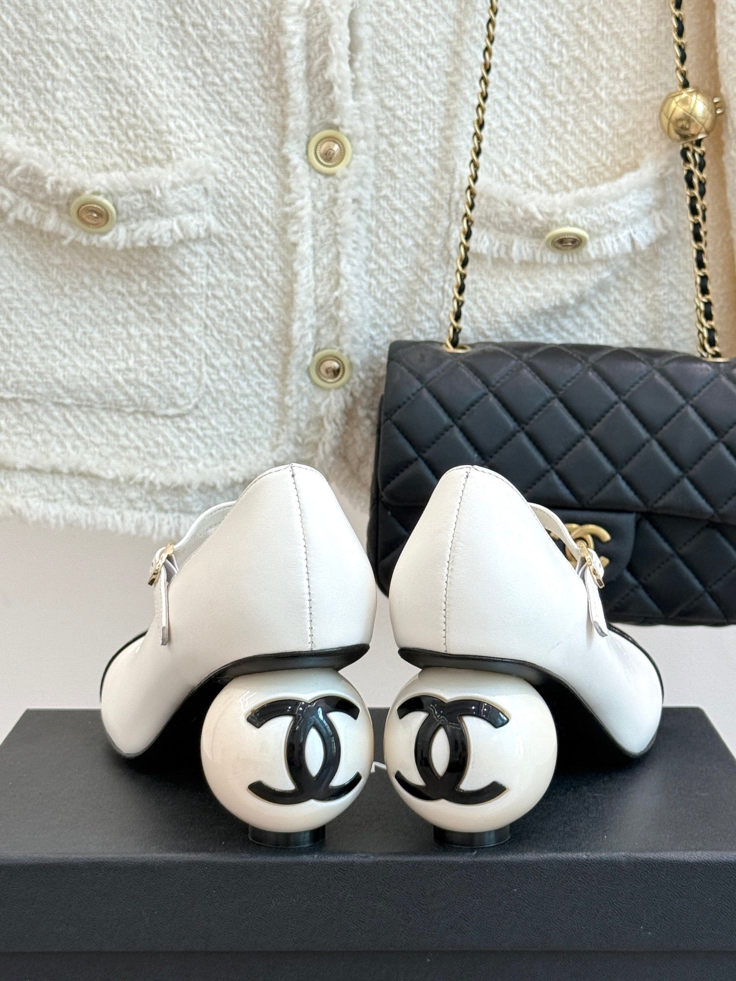 Chanel women's shoes with CC-logo soles, white leather uppers and black toe