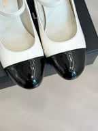 Chanel women's two-tone flats close-up, white leather with black patent toe