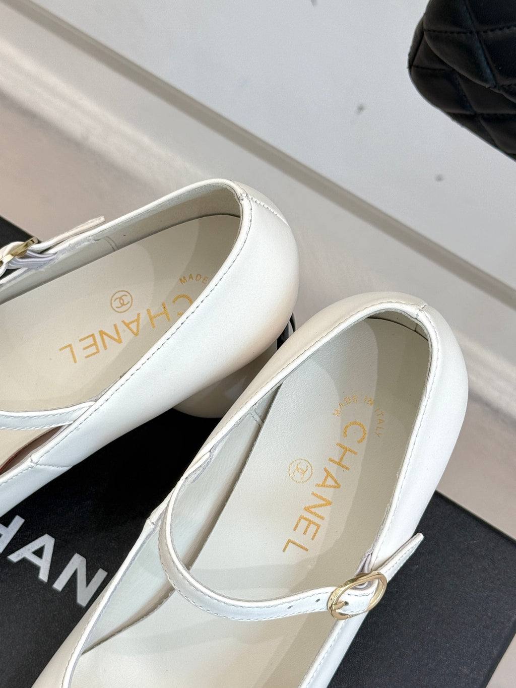 Chanel women's white flats with gold-tone buckle strap and logo lining