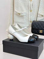 Chanel women's two-tone flats with white upper and black patent toe cap