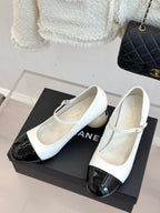 Chanel women's Mary Jane flats, white leather with black glossy toe panels
