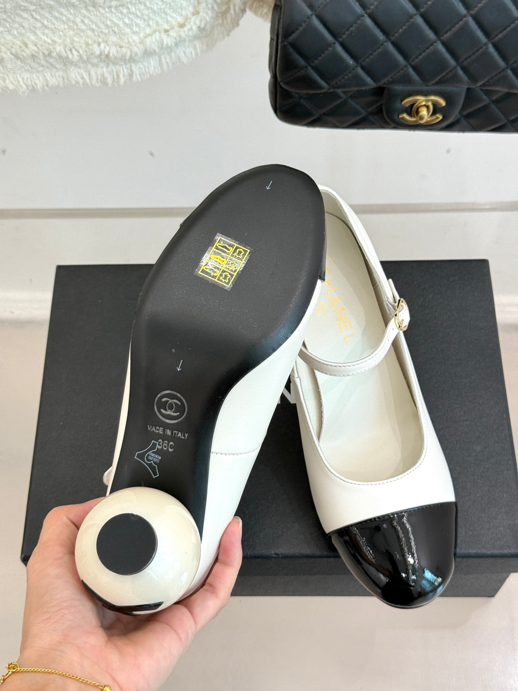Chanel women's shoe underside, white top with black sole and CC design