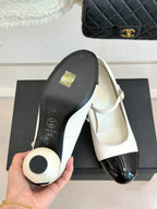 Chanel women's shoe underside, white top with black sole and CC design