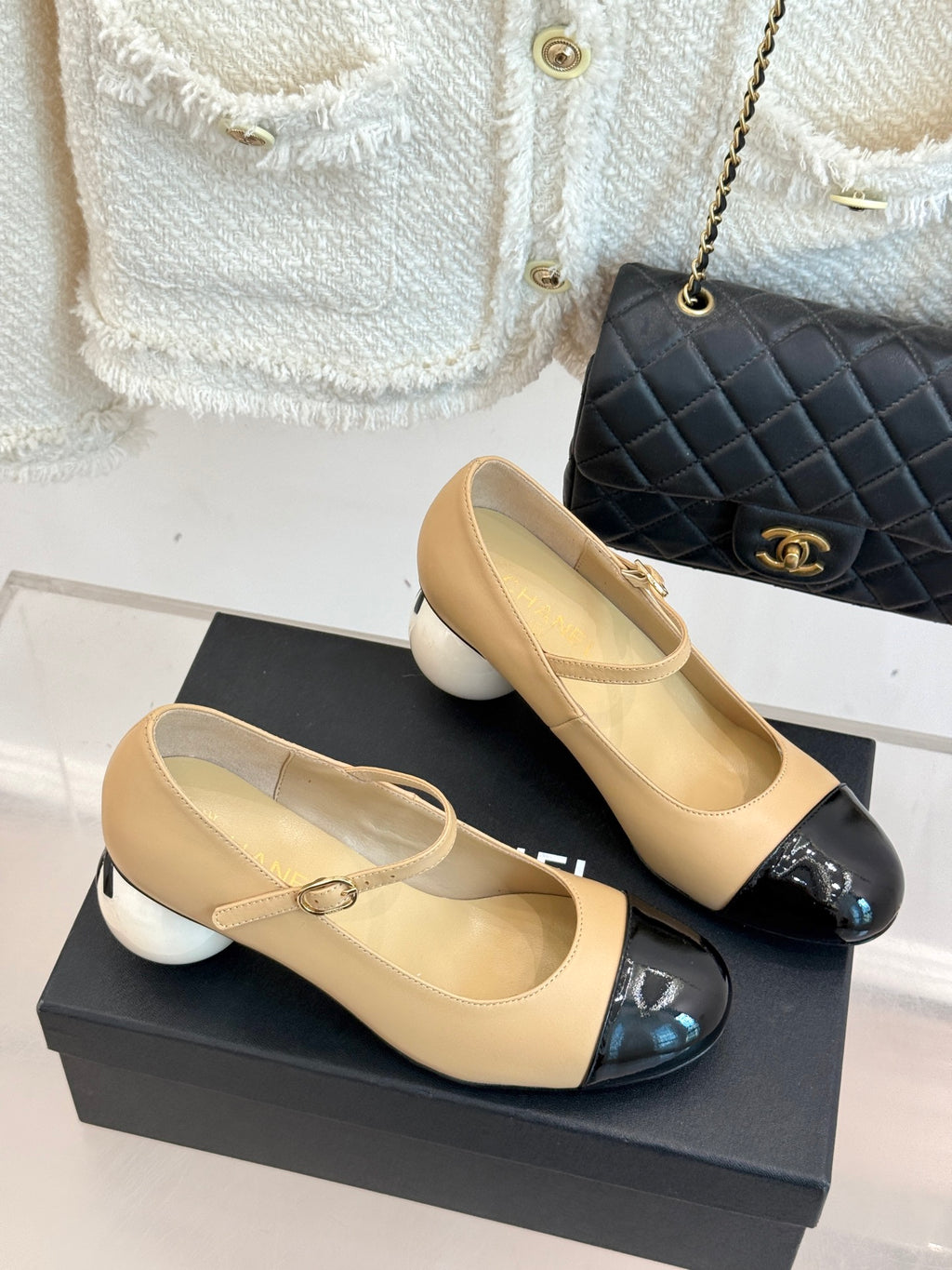 Two-tone Chanel flats: beige uppers with glossy black toe cap and bow