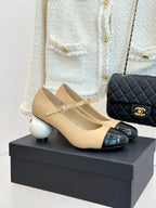 Women's Chanel flats in beige with glossy black toe cap and bow detail