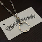 Silver-tone circular ring pendant necklace on a card, with chain and clasp visible.